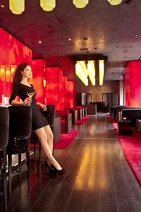 Woman in stylish Airport Lounge with drink